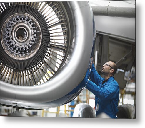 Expertise Metal Print featuring the photograph Aircraft engineer working on 737 jet engine in airport by Monty Rakusen