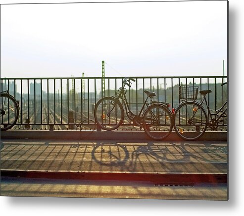 Shadow Metal Print featuring the photograph Bicycles Leaning On Fence by Janusz Ziob