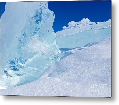 Abstract Metal Print featuring the photograph Clear glacier ice chunks with snow and blue sky by Stephan Pietzko