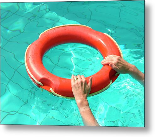 Life Preserver Metal Print featuring the photograph Hands Holding Onto Life Preserver Ring by Tony Craddock/science Photo Library