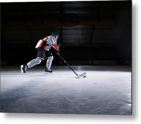 Focus Metal Print featuring the photograph Male Ice Hockey Player Skating With Puck by Mike Harrington