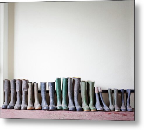 In A Row Metal Print featuring the photograph Rubber Boots In A Row by Ian Nolan