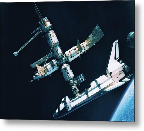 Horizontal Metal Print featuring the photograph The Space Shuttle Docked With A Space Station #1 by Stockbyte