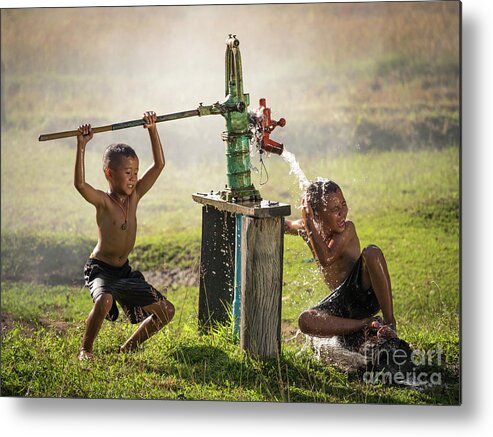 Sun Metal Print featuring the photograph Two young boy rocking groundwater bathe in the hot days. by Tosporn Preede