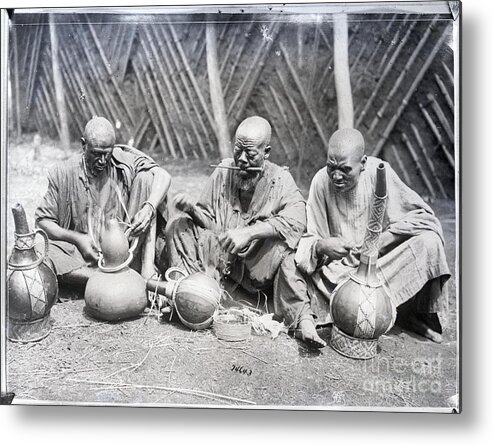 Working Metal Print featuring the photograph Africans Seated Ornamenting Pottery by Bettmann