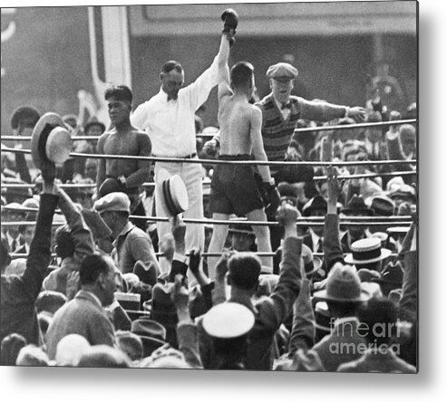 Hand Raised Metal Print featuring the photograph Referee Holds Boxers Hand In Victory by Bettmann