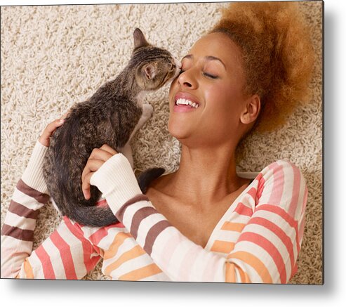 Pets Metal Print featuring the photograph Attractive Young African Woman Laying On Carpet With Cat by StudioThreeDots