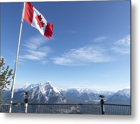 Scenics Metal Print featuring the photograph Canada, Alberta, Banff National Park, Canadian flag blowing above viewing deck, mountain range in background by Ascent/PKS Media Inc.