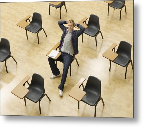 Hands Behind Head Metal Print featuring the photograph Confident college student sitting at desk in classroom by Chris Ryan