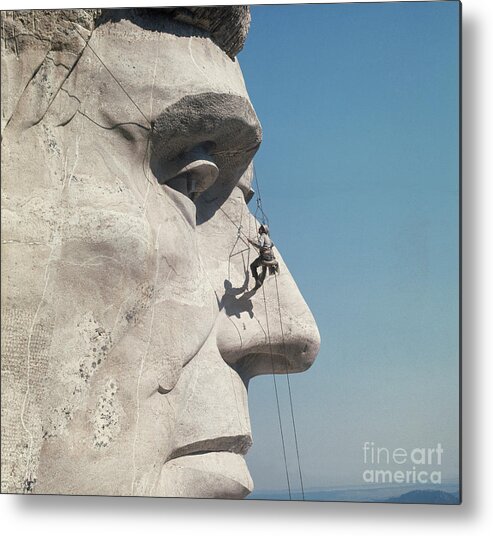 Mt Rushmore National Monument Metal Print featuring the photograph Repairman On Face Of Abraham Lincoln #1 by Bettmann