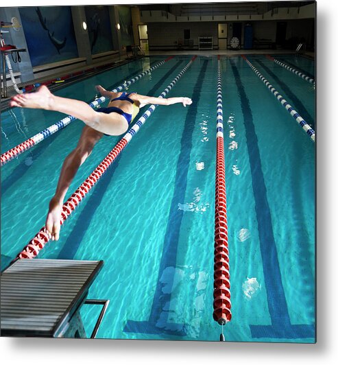 Diving Into Water Metal Print featuring the photograph Female Swimmer Diving Into Pool by Matt Henry Gunther