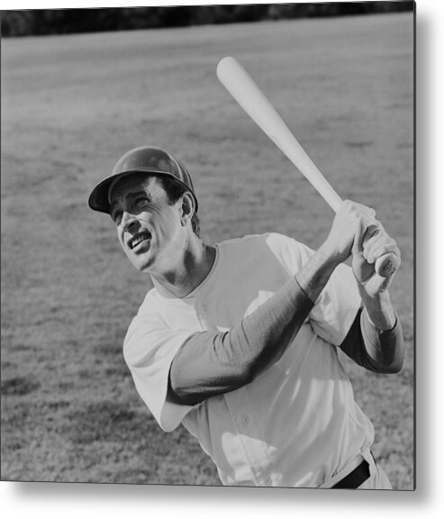 Sports Helmet Metal Print featuring the photograph Baseball player swinging baseball bat by Tom Kelley Archive
