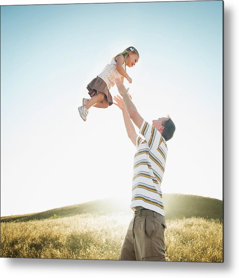 Human Arm Metal Print featuring the photograph Caucasian Father Lifting Daughter by Erik Isakson