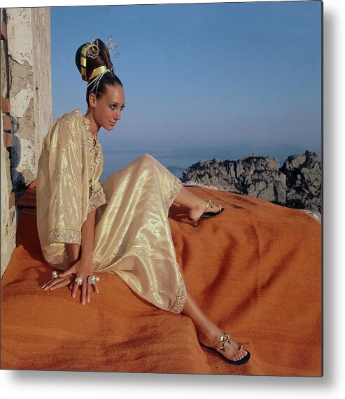 Updo Metal Print featuring the photograph Marisa Berenson Wearing A Gold Caftan By Tina by Henry Clarke