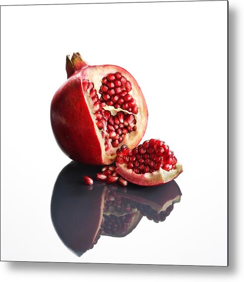 Pomegranate Metal Print featuring the photograph Pomegranate opened up on reflective surface by Johan Swanepoel