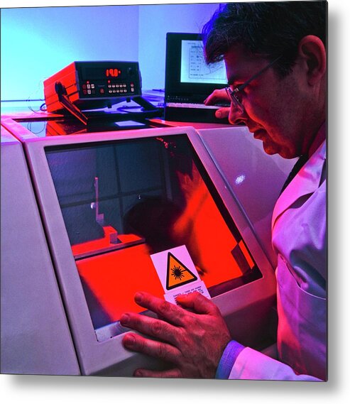 Laser Metal Print featuring the photograph Technician Testing A Dental Laser On A Tooth by Science Photo Library