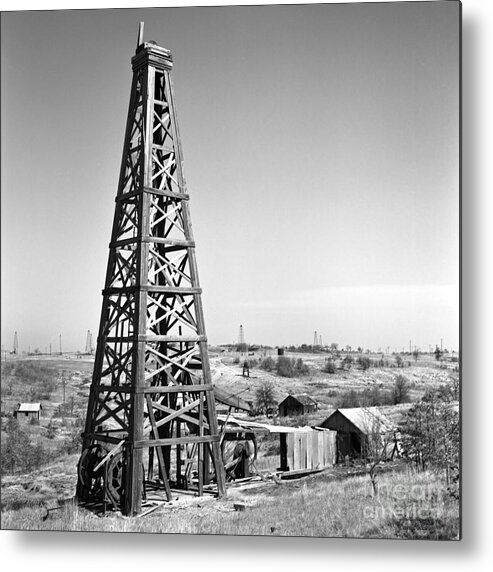 Oilfield Metal Print featuring the photograph Old Wooden Derrick by Larry Keahey