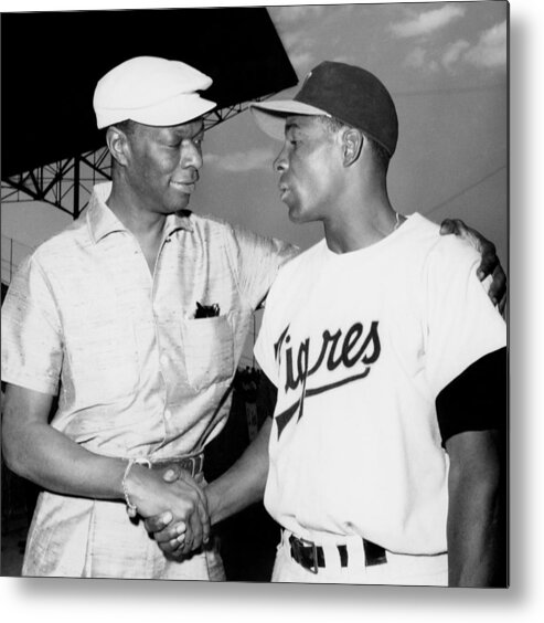1950-1959 Metal Print featuring the photograph Nat King Cole And Minnie Minoso by Michael Ochs Archives