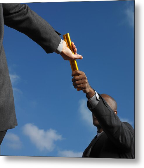 Young Men Metal Print featuring the photograph Businessman Passing Baton To Businessman, Low Angle View by George Doyle