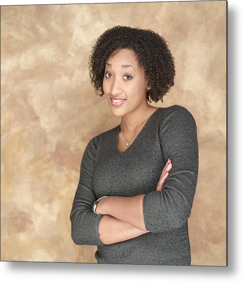 20-29 Years Metal Print featuring the photograph Portrait Of A Young African American Woman In A Grey Sweater As She Folds Her Arms And Smiles by Photodisc