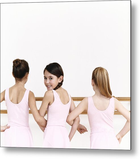 Ballet Dancer Metal Print featuring the photograph Rear View of a Line of Young, Female Ballet Dancer Practicing in the Dance Studio With One Ballerina Looking Behind Her by Digital Vision.