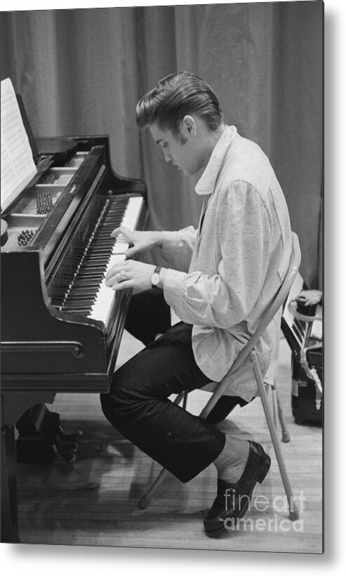 Elvis Presley Metal Print featuring the photograph Elvis Presley on piano while waiting for a show to start 1956 by The Harrington Collection