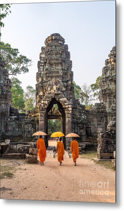 Angkor Metal Print featuring the photograph Monks with umbrella walking into Angkor Wat temple - Cambodia by Matteo Colombo