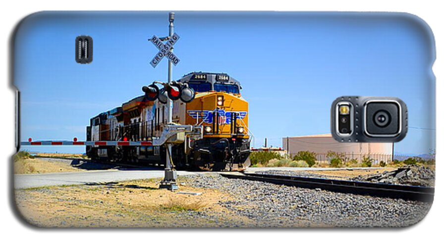 Railway Crossing; Railroad Crossing; Train Crossing; Union Pacific; Freight Train; Yellow; Blue; Green; Red; Water Storage; Train Tracks; Train Signal; Mojave Desert; Mohave Desert; Antelope Valley; Joe Lach Galaxy S5 Case featuring the photograph Railway Crossing by Joe Lach