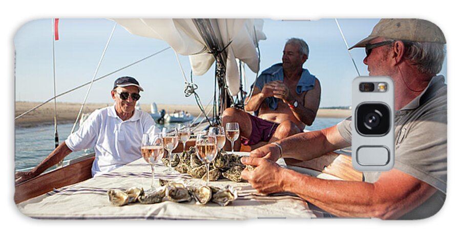 Wine Glass Galaxy Case featuring the photograph Three Men Having Oyster And Wine #1 by Christophe Launay