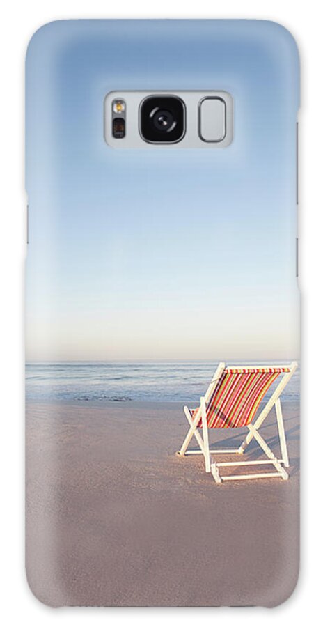Tranquility Galaxy Case featuring the photograph Lawn Chair On Empty Beach by Zero Creatives