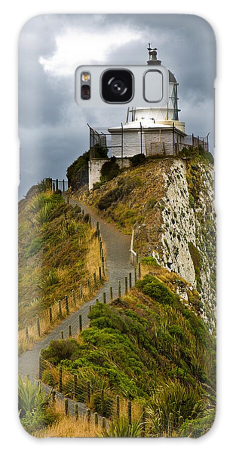 Beach Galaxy S8 Case featuring the photograph Nugget Point Light House and dark clouds in the sky by U Schade