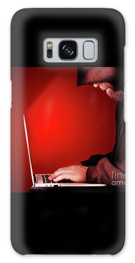 Computer Galaxy Case featuring the photograph Hooded computer hacker red background by Simon Bratt