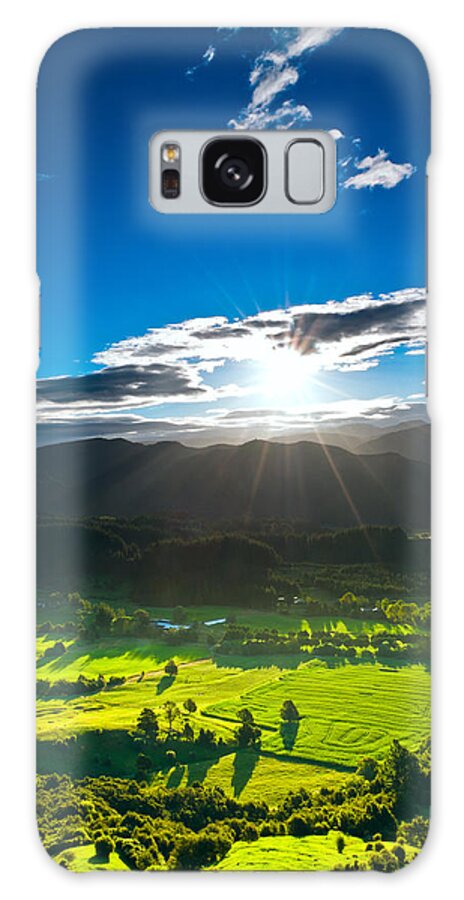 Agricultural Galaxy Case featuring the photograph Sunrays flood farmland during sunset by U Schade