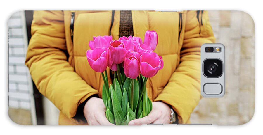 Care Galaxy Case featuring the photograph Blond Man In A Yellow Winter Jacket With A Bouquet Of Tulips In Hands #1 by Cavan Images