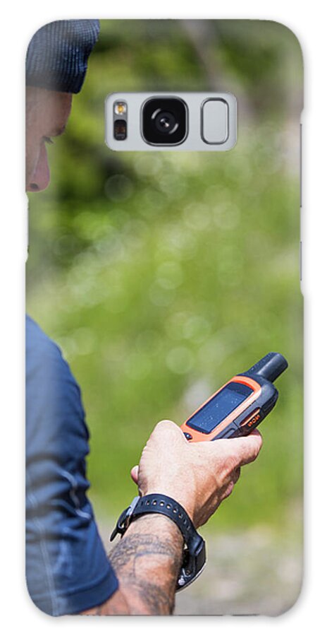 Gps Galaxy Case featuring the photograph Man Navigates While Hiking Using A Gps Device #1 by Cavan Images