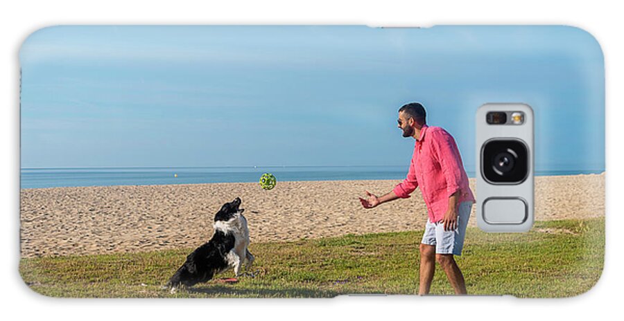 Beach Galaxy Case featuring the photograph Bearded Man Playing With Dog At Beach In Sunny Day #4 by Cavan Images