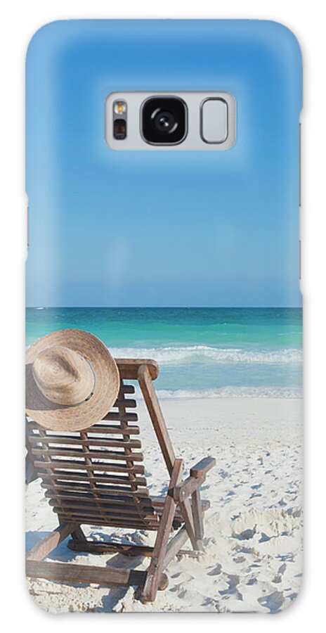 Scenics Galaxy Case featuring the photograph Beach Chair With A Hat On An Empty Beach by Sasha Weleber