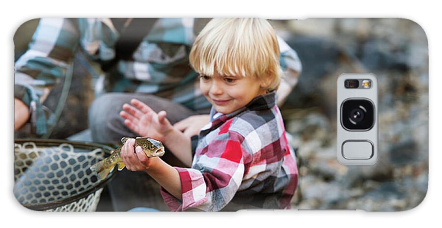 Boy Galaxy Case featuring the photograph Boy Holding Fish While Standing By Father by Cavan Images