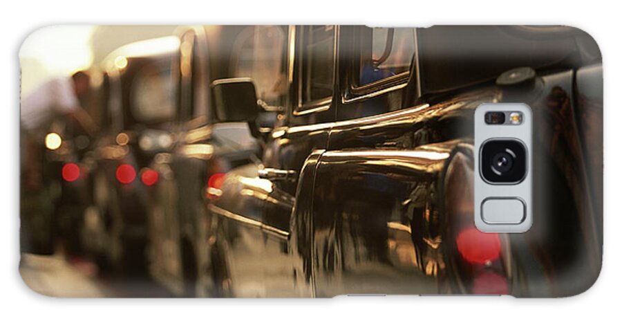 In A Row Galaxy Case featuring the photograph England, London, Row Of Parked Taxis by Walter Bibikow