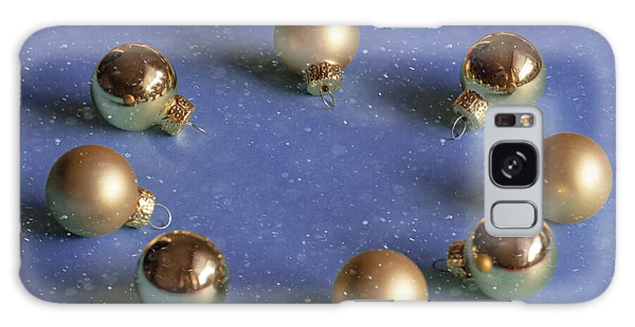 Decoration Galaxy Case featuring the photograph Golden christmas balls on the snowy background by Marina Usmanskaya