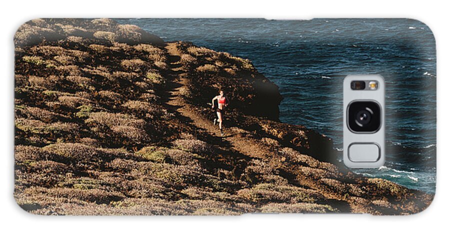 Woman Galaxy Case featuring the photograph Pulled Back View Of Woman Running On Trail By The Sea by Cavan Images