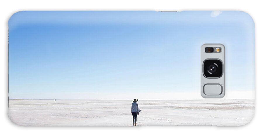 Woman Galaxy Case featuring the photograph Rear View Of Woman Walking At Great Salt Lake Against Blue Sky During Sunny Day by Cavan Images