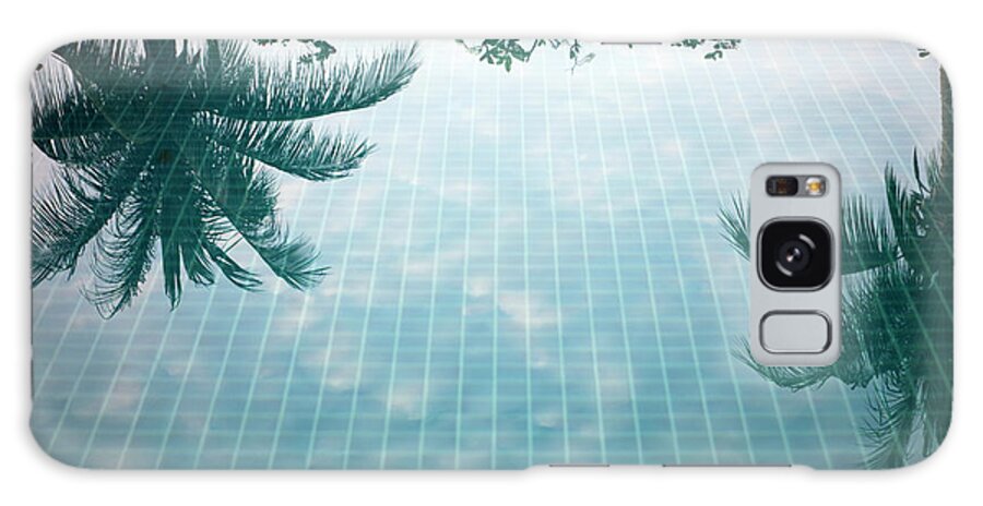 Tranquility Galaxy Case featuring the photograph Reflection Of Palm Trees In A Swimming by Frank Rothe