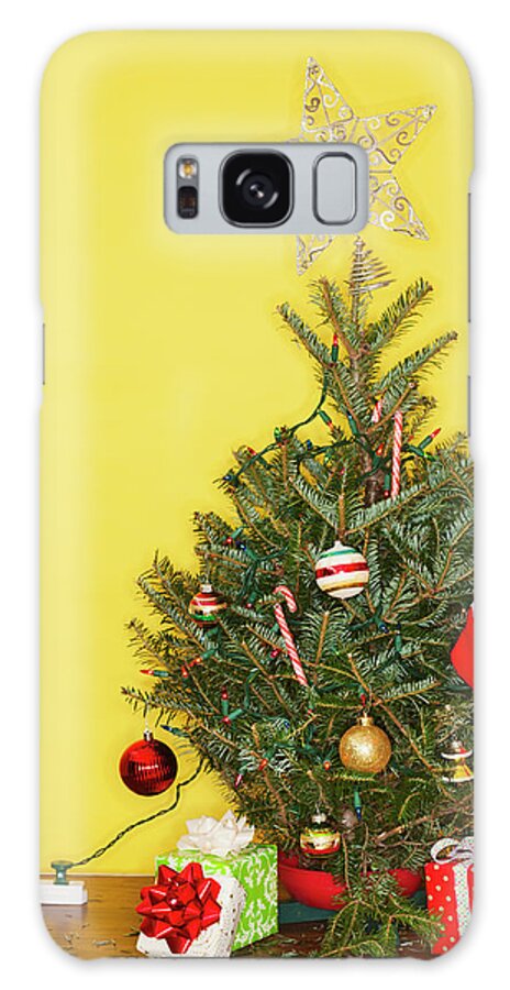 Large Group Of Objects Galaxy Case featuring the photograph Small Christmas Tree Against Yellow by Tetra Images