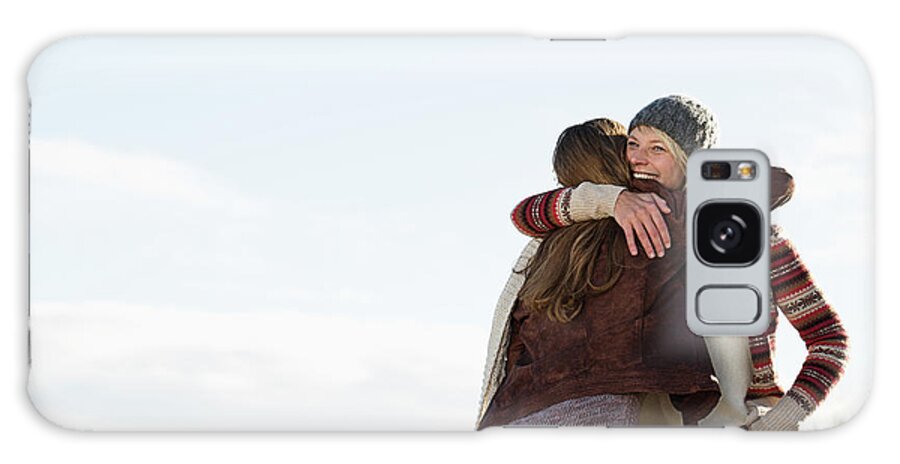 Mid Adult Women Galaxy Case featuring the photograph Smiling Women Hugging On Beach by Nils Hendrik Mueller