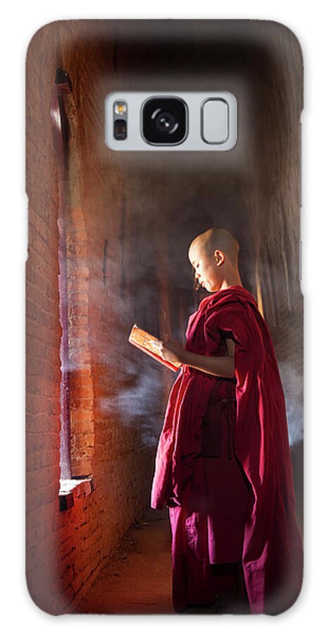 Tranquility Galaxy Case featuring the photograph Young Buddhist Monk Reading In Pagoda by Peter Adams