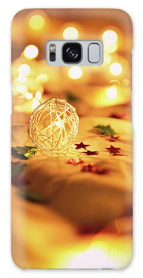 Lights Galaxy Case featuring the photograph Blurred golden Christmas lights with decorations on rumpled bed by Mendelex Photography