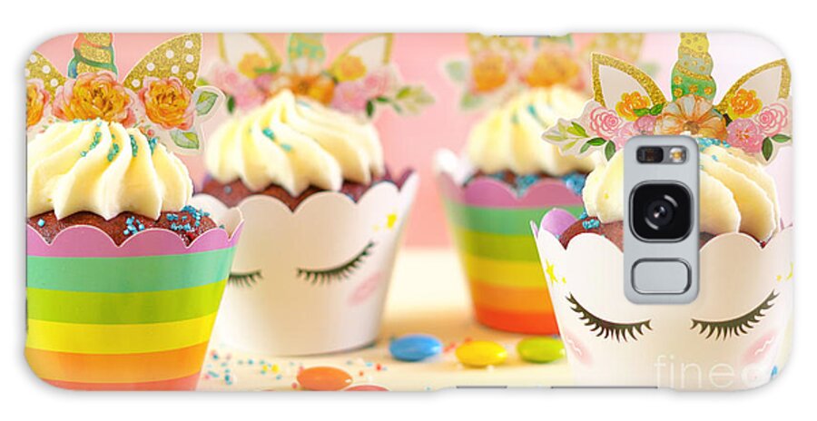 Cupcake Galaxy Case featuring the photograph Decorating children's birthday party unicorn themed cupcakes, closeup. by Milleflore Images