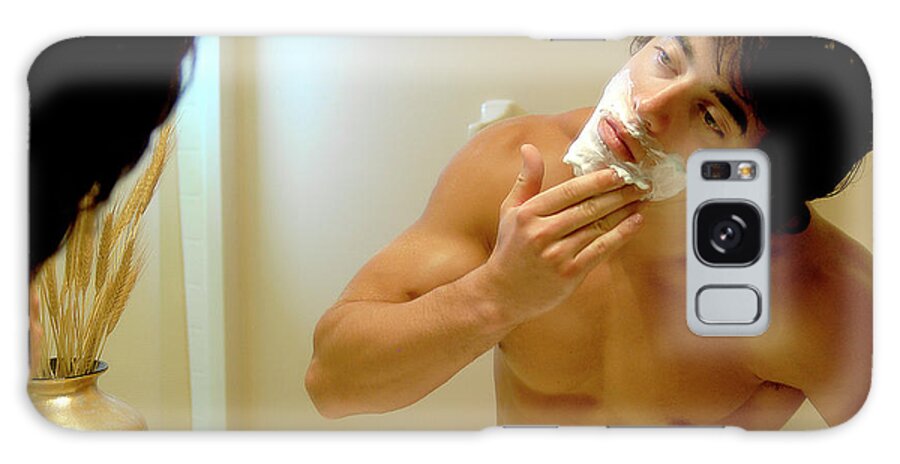 Shave Galaxy Case featuring the photograph Handsome young man is putting on shaving cream. by Gunther Allen