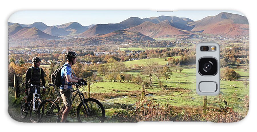 Young Galaxy Case featuring the photograph Young couple on bikes looking over Cumbrian fells, England, UK by Bryan Attewell